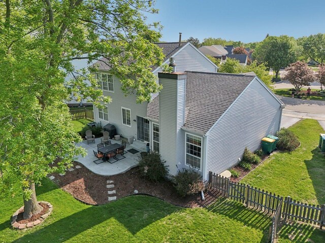 220 Carters Grove Ct, Grayslake, IL 60030 - rear view of house featuring a patio, a fenced backyard, entry steps, a chimney, and a shingled roof