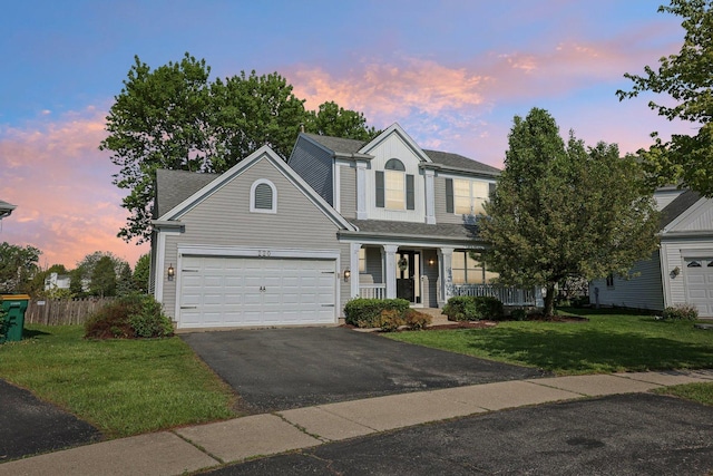 220 Carters Grove Ct, Grayslake, IL 60030 - traditional-style home featuring covered porch, asphalt driveway, a shingled roof, and a garage