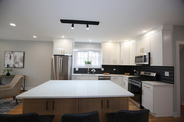 3324 N Nordica Ave, Chicago, IL 60634 - kitchen with appliances with stainless steel finishes, tasteful backsplash, light countertops, a kitchen bar, and a center island