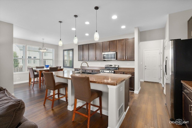 1133 Daytona Way, Pingree Grove, IL 60140 - kitchen featuring appliances with stainless steel finishes, a kitchen bar, recessed lighting, and dark wood finished floors