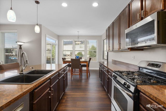1133 Daytona Way, Pingree Grove, IL 60140 - kitchen with stainless steel appliances, dark wood-style floors, dark countertops, recessed lighting, and dark brown cabinetry
