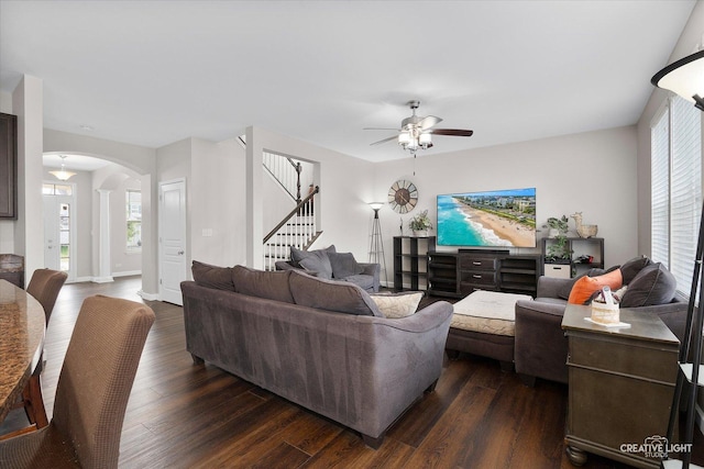 1133 Daytona Way, Pingree Grove, IL 60140 - living area with arched walkways, ceiling fan, stairs, and dark wood-style flooring