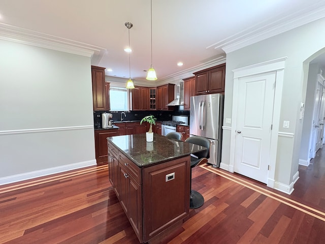 818 W Aldine Ave Unit 3, Chicago, IL 60657 - kitchen featuring stainless steel appliances, wall chimney range hood, a breakfast bar area, dark wood-type flooring, and crown molding