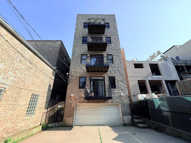 818 W Aldine Ave Unit 3, Chicago, IL 60657 - view of apartment building / complex featuring concrete driveway and a garage