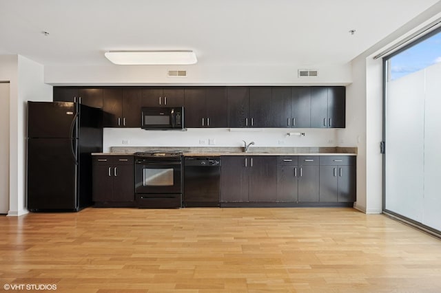 1740 Oak Ave Unit 103, Evanston, IL 60201 - kitchen with black appliances, light wood-type flooring, light countertops, and dark brown cabinetry