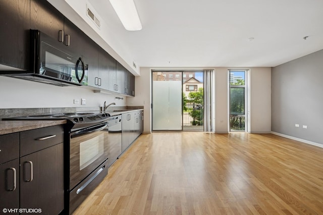 1740 Oak Ave Unit 103, Evanston, IL 60201 - kitchen featuring black appliances and light wood-style flooring