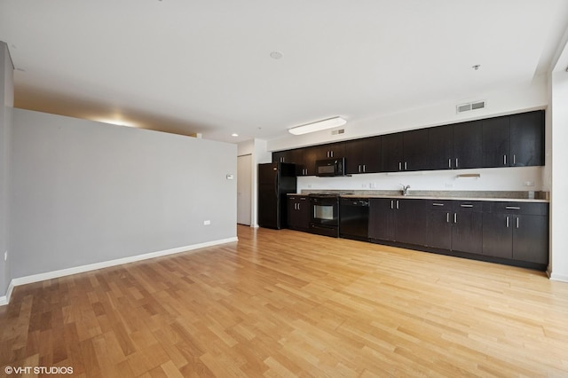 1740 Oak Ave Unit 103, Evanston, IL 60201 - kitchen featuring black appliances, light wood-style floors, and light countertops