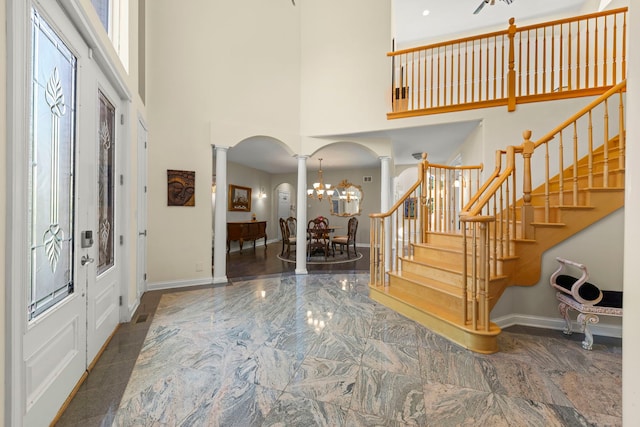 2308 Fleetwood Ct, Naperville, IL 60565 - entrance foyer with ornate columns, arched walkways, a high ceiling, stairway, and marble tiled flooring