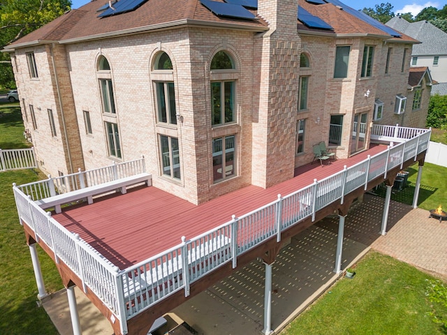 2308 Fleetwood Ct, Naperville, IL 60565 - back of house featuring a deck, solar panels, brick siding, and a chimney