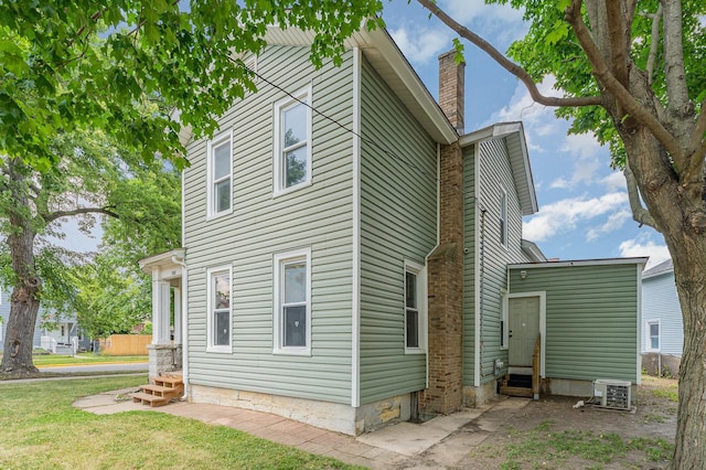 528 E Benton St, Aurora, IL 60505 - view of home's exterior featuring entry steps and a chimney