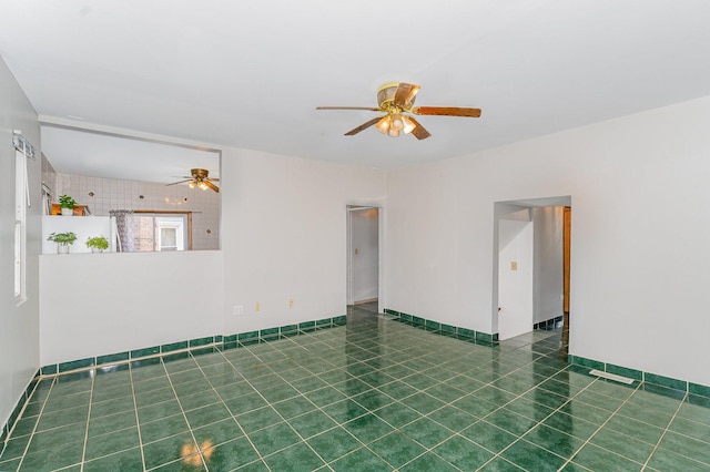528 E Benton St, Aurora, IL 60505 - tiled empty room with a ceiling fan