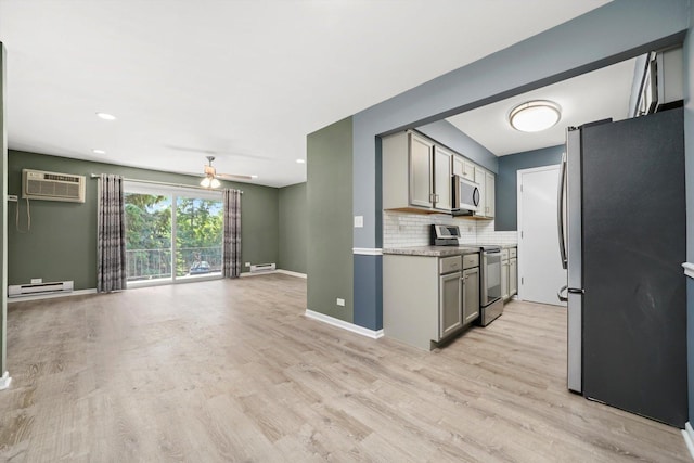 5701 W 129th St Unit 2B, Crestwood, IL 60418 - kitchen featuring stainless steel appliances, a baseboard heating unit, an AC wall unit, open floor plan, and light wood-style flooring