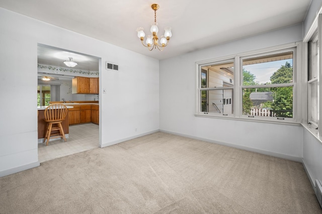 115 Fair St, Sycamore, IL 60178 - empty room with light carpet, a chandelier, and baseboard heating