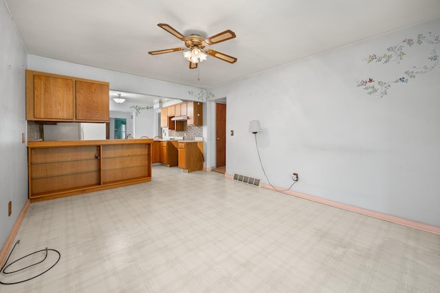 115 Fair St, Sycamore, IL 60178 - unfurnished living room with a ceiling fan and light floors
