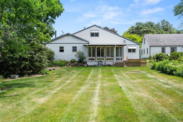 115 Fair St, Sycamore, IL 60178 - rear view of house featuring a sunroom and a yard