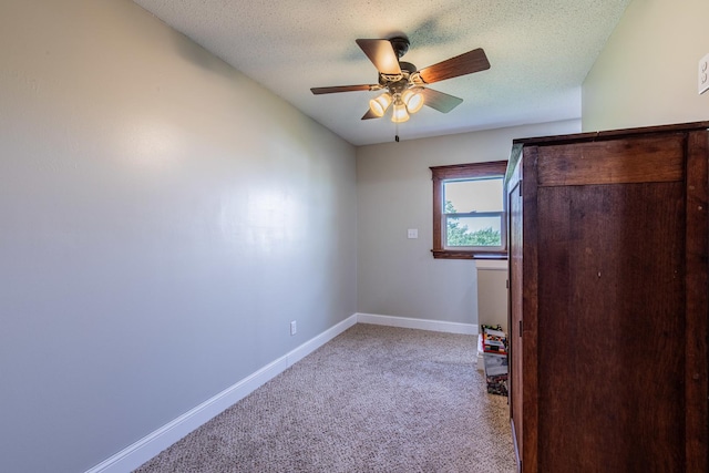 4116 E 13th Rd, Earlville, IL 60518 - unfurnished bedroom featuring light colored carpet, a textured ceiling, and ceiling fan