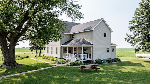 4116 E 13th Rd, Earlville, IL 60518 - back of house featuring covered porch, a lawn, and a shingled roof