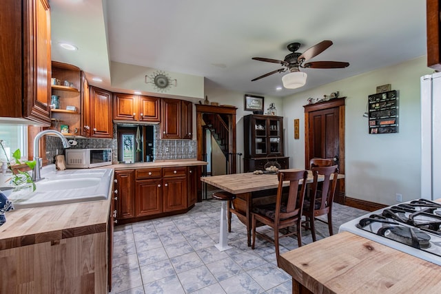 4116 E 13th Rd, Earlville, IL 60518 - kitchen featuring butcher block counters, white microwave, tasteful backsplash, ceiling fan, and open shelves