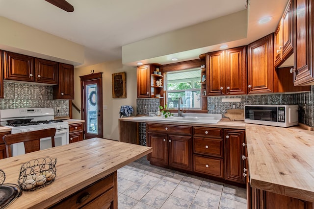 4116 E 13th Rd, Earlville, IL 60518 - kitchen with butcher block countertops, white range with gas stovetop, tasteful backsplash, and open shelves
