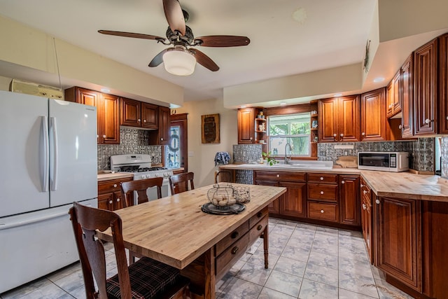 4116 E 13th Rd, Earlville, IL 60518 - kitchen featuring white appliances, backsplash, open shelves, ceiling fan, and butcher block counters