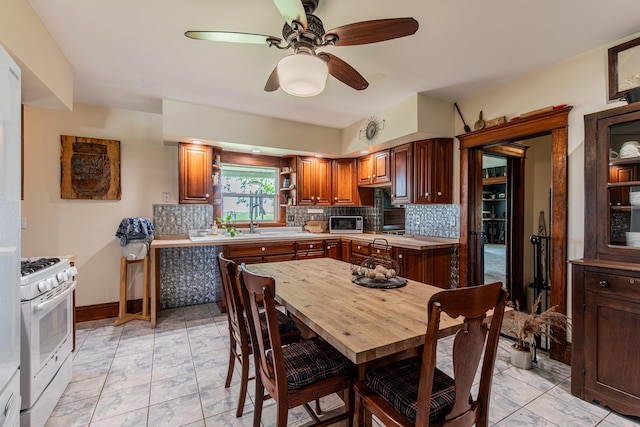 4116 E 13th Rd, Earlville, IL 60518 - kitchen featuring white range with gas stovetop, backsplash, light countertops, ceiling fan, and open shelves