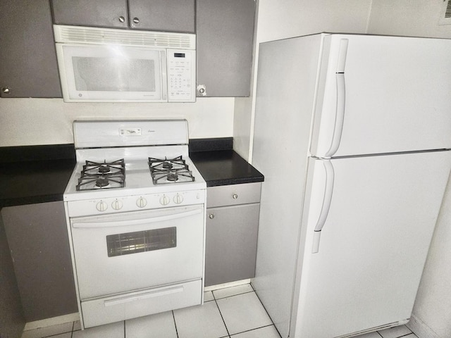 253 E Delaware Pl Unit 8F, Chicago, IL 60611 - kitchen featuring white appliances and light tile patterned floors