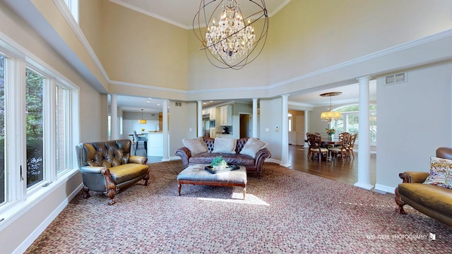 2520 Hanford Ln, Aurora, IL 60502 - carpeted living room with decorative columns, a chandelier, healthy amount of natural light, a towering ceiling, and crown molding