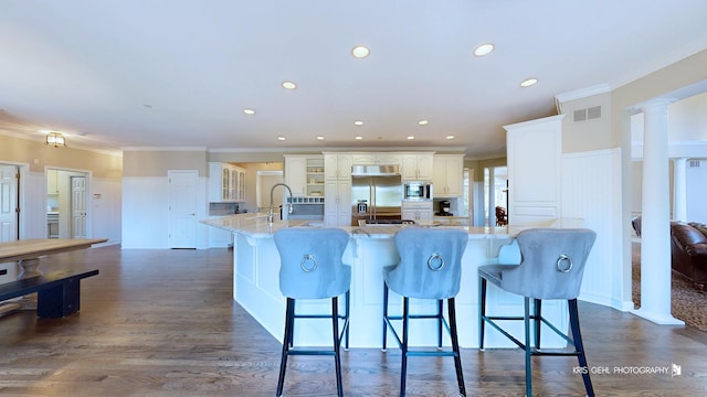 2520 Hanford Ln, Aurora, IL 60502 - kitchen with built in appliances, ornamental molding, a breakfast bar, recessed lighting, and glass insert cabinets