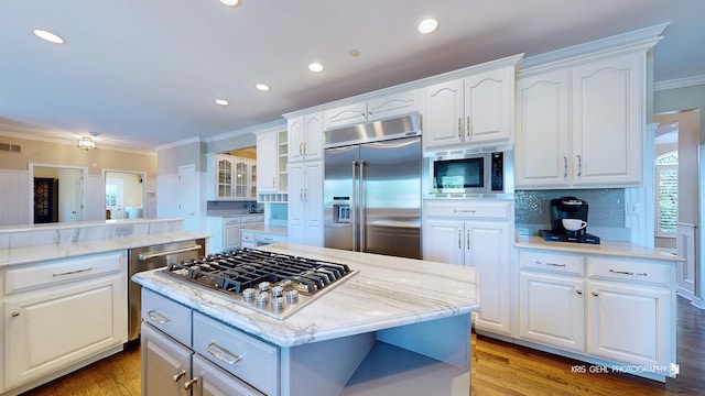 2520 Hanford Ln, Aurora, IL 60502 - kitchen featuring built in appliances, crown molding, backsplash, white cabinets, and light stone countertops