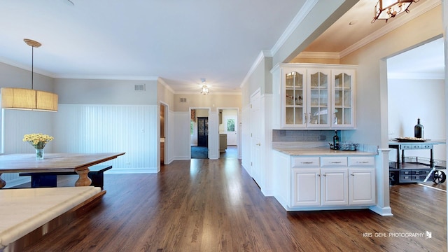 2520 Hanford Ln, Aurora, IL 60502 - kitchen with dark wood-style floors, glass insert cabinets, light countertops, white cabinetry, and wainscoting