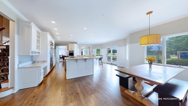2520 Hanford Ln, Aurora, IL 60502 - kitchen with crown molding, oven, white cabinetry, dark wood-type flooring, and recessed lighting