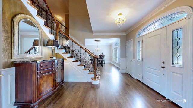 2520 Hanford Ln, Aurora, IL 60502 - entryway featuring a chandelier, dark wood-style floors, stairway, crown molding, and healthy amount of natural light