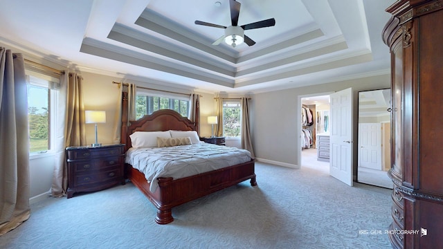 2520 Hanford Ln, Aurora, IL 60502 - bedroom with light colored carpet, a raised ceiling, ornamental molding, a walk in closet, and ceiling fan