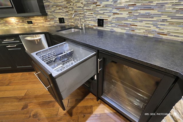2520 Hanford Ln, Aurora, IL 60502 - kitchen with dishwasher, backsplash, dark countertops, and wood finished floors