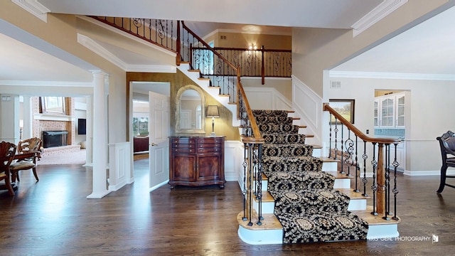 2520 Hanford Ln, Aurora, IL 60502 - stairs with wood finished floors, a fireplace, crown molding, and a high ceiling