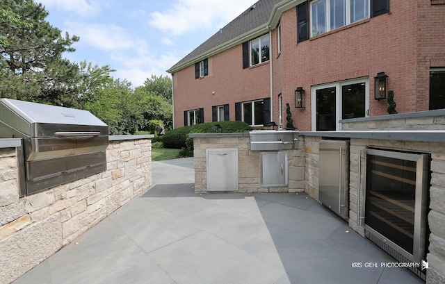 2520 Hanford Ln, Aurora, IL 60502 - view of patio featuring beverage cooler and an outdoor kitchen