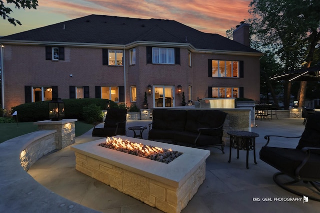 2520 Hanford Ln, Aurora, IL 60502 - back of house featuring a patio area, a chimney, and an outdoor living space with a fire pit