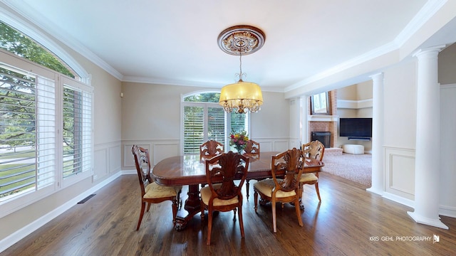 2520 Hanford Ln, Aurora, IL 60502 - dining room with plenty of natural light, a decorative wall, a chandelier, ornate columns, and wood finished floors
