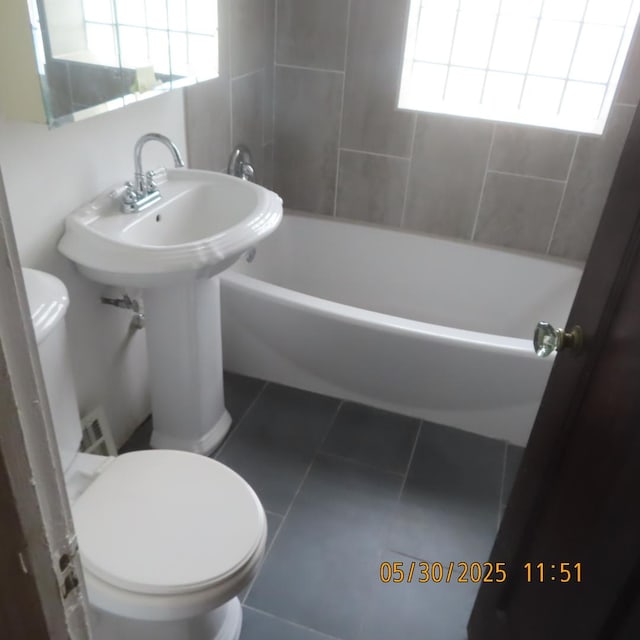 7741 S Indiana Ave, Chicago, IL 60619 - full bath with tile patterned flooring, healthy amount of natural light, and shower / washtub combination