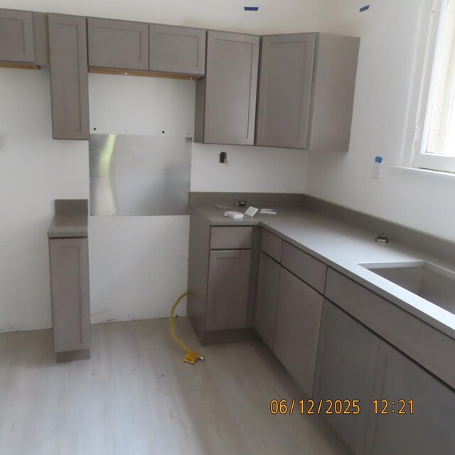 7741 S Indiana Ave, Chicago, IL 60619 - kitchen featuring light wood-style floors and gray cabinetry