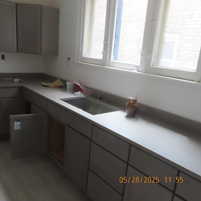 7741 S Indiana Ave, Chicago, IL 60619 - kitchen with gray cabinets, wood finished floors, and light countertops