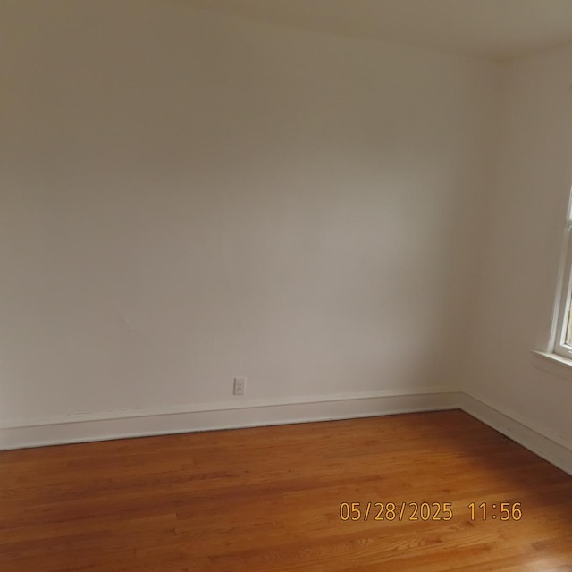 7741 S Indiana Ave, Chicago, IL 60619 - empty room featuring wood finished floors and baseboards