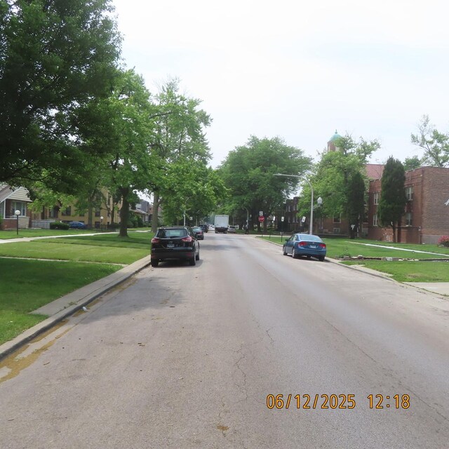 7741 S Indiana Ave, Chicago, IL 60619 - view of asphalt road with curbs, street lighting, and sidewalks