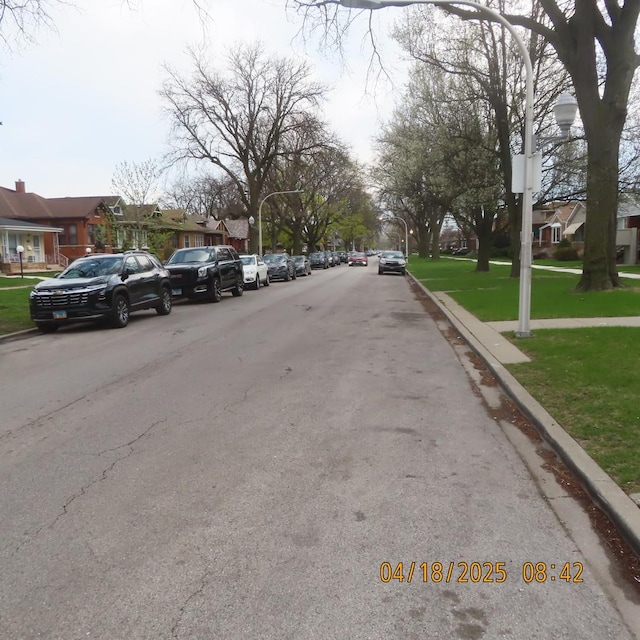 7741 S Indiana Ave, Chicago, IL 60619 - view of asphalt road with curbs and a residential view