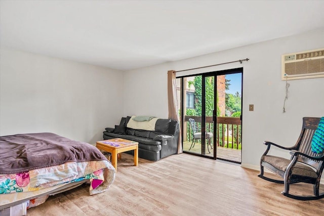 413 Berkshire Dr Unit 22, Crystal Lake, IL 60014 - bedroom with an AC wall unit, access to exterior, and wood finished floors