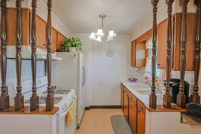 3750 N Octavia Ave, Chicago, IL 60634 - kitchen featuring brown cabinets, light wood-style floors, extractor fan, and a chandelier