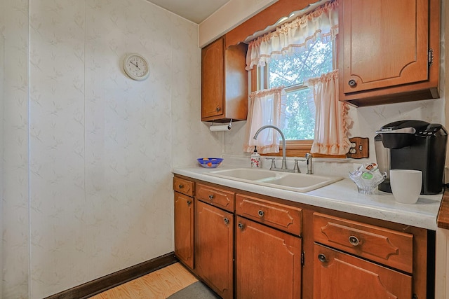 3750 N Octavia Ave, Chicago, IL 60634 - kitchen with brown cabinetry, light countertops, and light wood-style floors