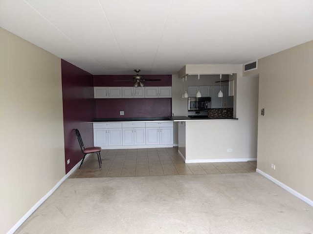220 S Roselle Rd Unit 324, Schaumburg, IL 60193 - kitchen featuring stainless steel microwave, a ceiling fan, carpet flooring, tasteful backsplash, and tile patterned floors