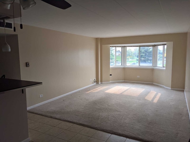 220 S Roselle Rd Unit 324, Schaumburg, IL 60193 - empty room featuring carpet flooring, tile patterned floors, and a ceiling fan