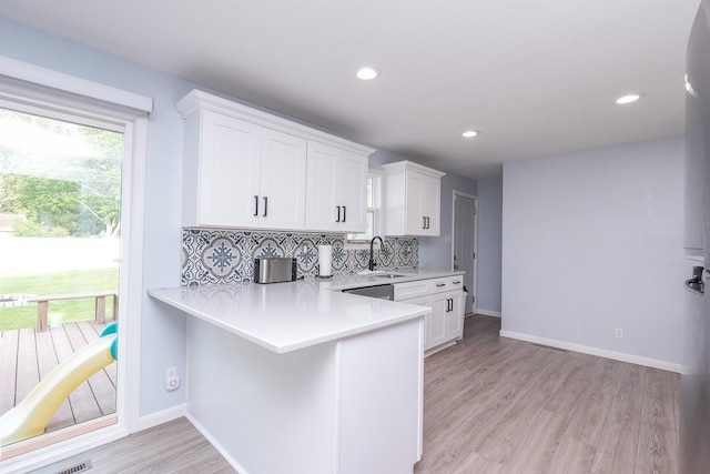 620 Edwin Dr, Bourbonnais, IL 60914 - kitchen with light countertops, light wood-type flooring, white cabinets, decorative backsplash, and recessed lighting